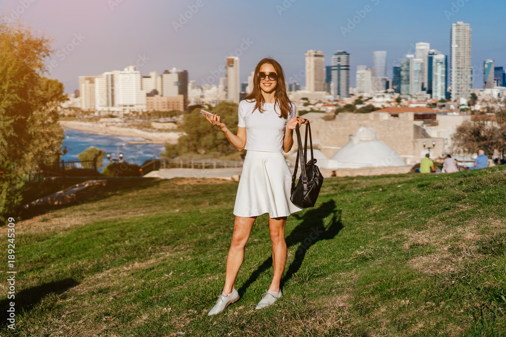 Fototapeta premium A sweet girl with dark hair in the central park