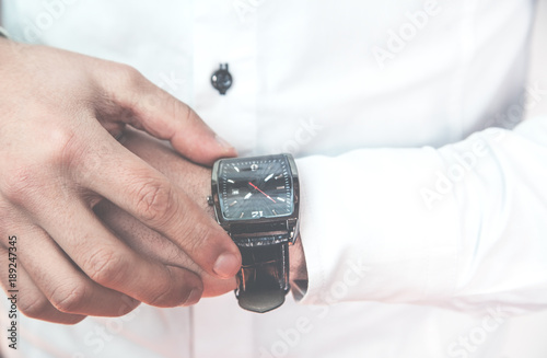 Businessman fixing his wristwatch.