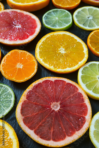 citrus fruit slices on dark surface