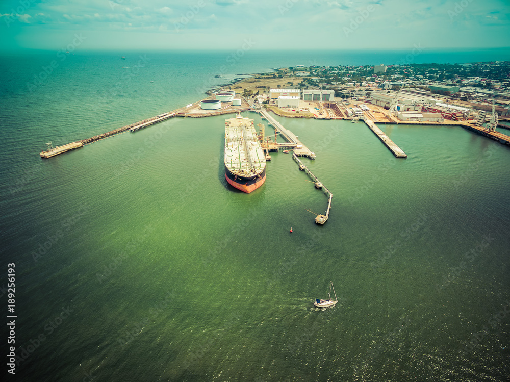 Aerial view of oil tanker moored at industrial port. Williamstown, Victoria, Australia