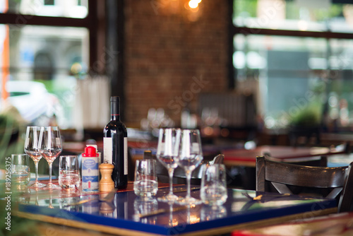 Table in brasserie with bottle of wine and glasses