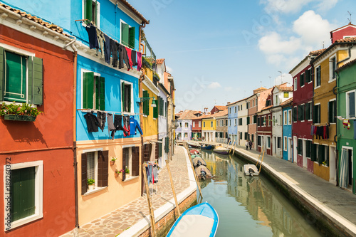 Colorful houses by canal in Burano, Venice, Italy.
