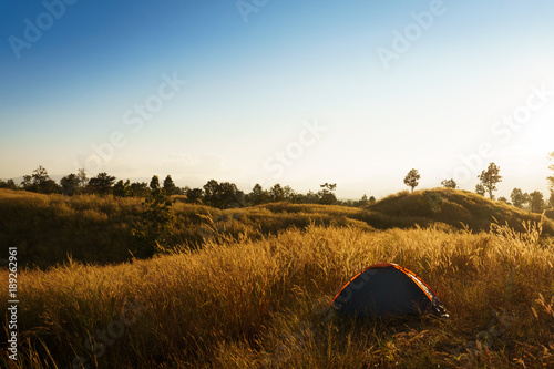 outdoors camping grass highlands mountain in the Sunset