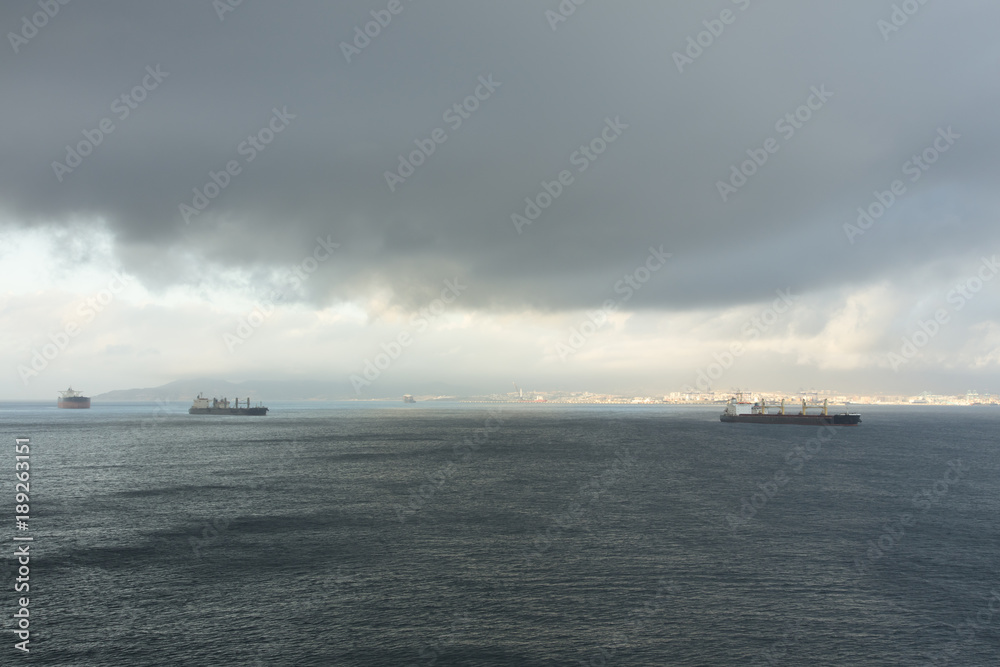 Fototapeta premium Storm clouds over ships in Gibraltar harbour