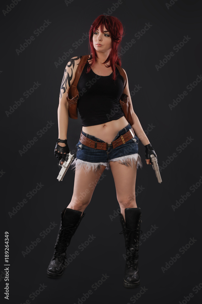 Portrait of sexy woman posing in studio with gun Portrait of sexy woman posing in studio with gun