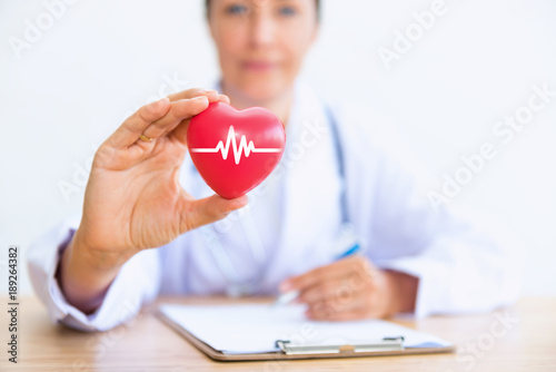 Portrait of woman doctor with holding red heart, Health care concept photo