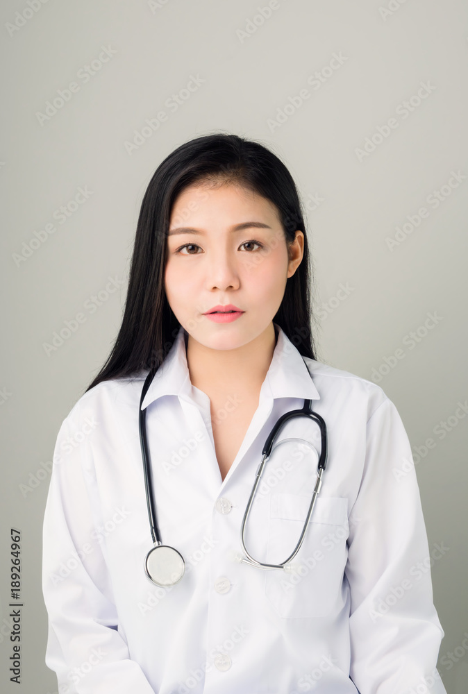 The women doctor stands and has stethoscope hanging on his neck. The women doctor stands and has stethoscope hanging on his neck.