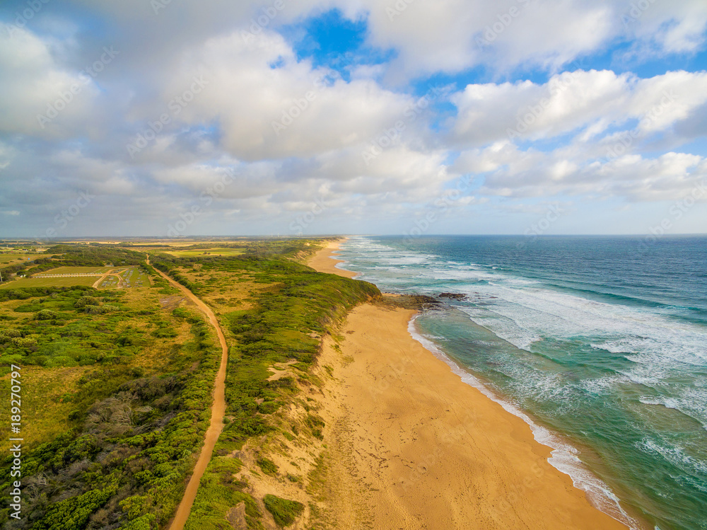 Aerial view of Australian countryside and ocean coastline at sunset