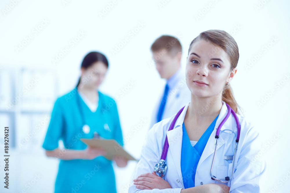 Attractive female doctor in front of medical group. Attractive female doctor in front of medical group.