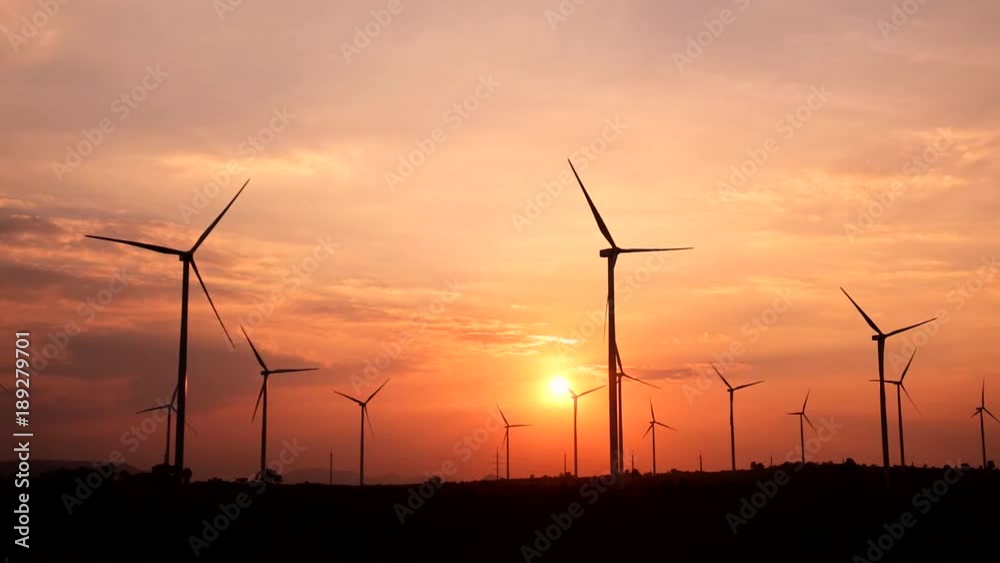 The sun is behind the wind turbine used to generate electricity. Renewable Energy Concepts and Help the World Save Energy The sun is behind the wind turbine used to generate electricity. Renewable Energy Concepts and Help the World Save Energy