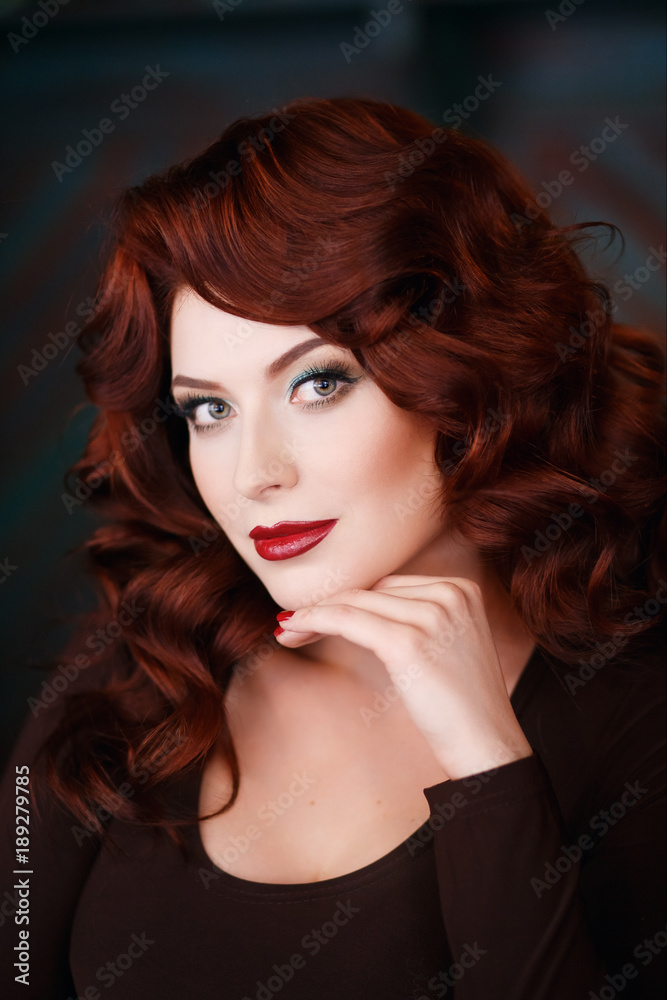 Beautiful girl with makeup, wavy and red hair, red burgundy lips, looks  into frame. Stock Photo | Adobe Stock
