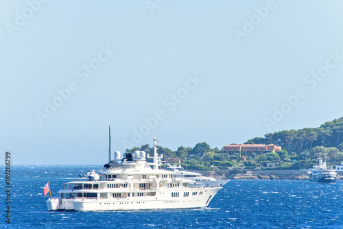 Daylight close-up view to white yachts with helicopter on board © frimufilms