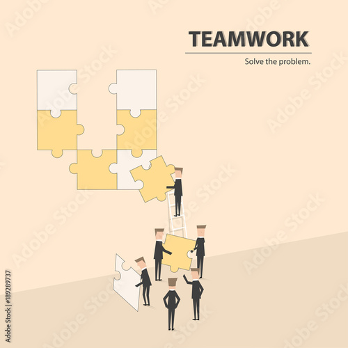 Businessmen helping together to fulfill the puzzle by pieces together in a logical way, in order to arrive at the correct solution.