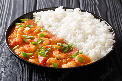 American cuisine: spicy gumbo with prawns, sausage and rice close-up on a plate. horizontal