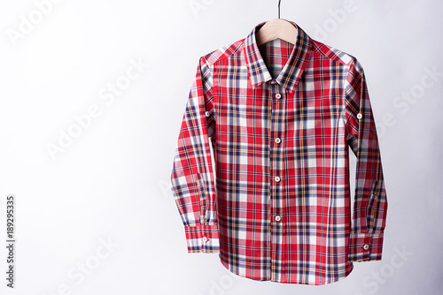 Red tartan shirt folded on white background
