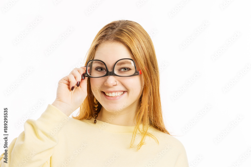 Young woman with glasses on her head smiling Young woman with glasses on her head smiling