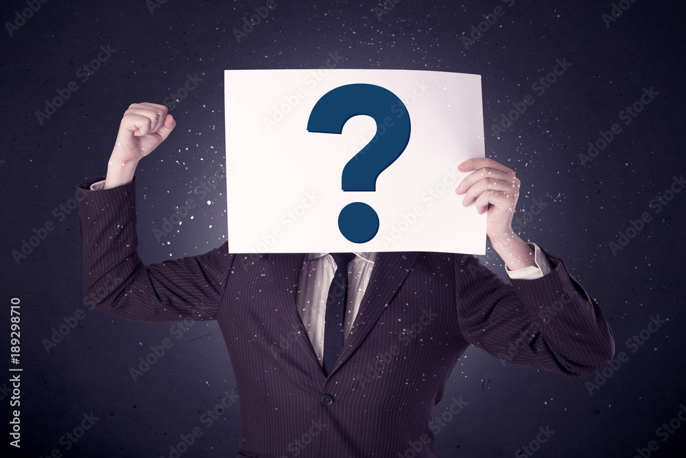 Businessman holding paper with question marks Businessman holding paper with question marks
