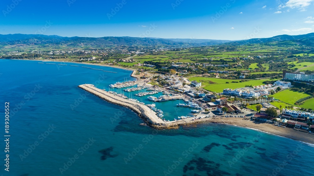 Aerial bird's eye view of Latchi port, Akamas peninsula, Polis Chrysochous, Paphos,Cyprus. Latsi harbour with boats and yachts, fish restaurant, promenade, beach tourist area and mountains from above