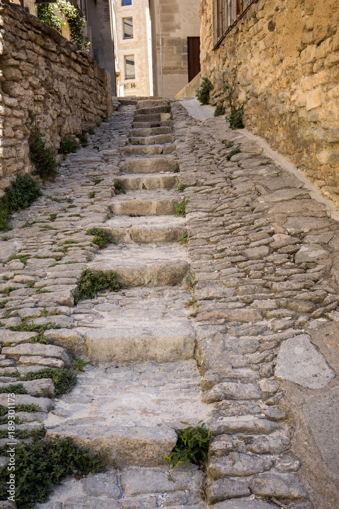 Steep alley with medieval houses in Gordes. Provence, France
