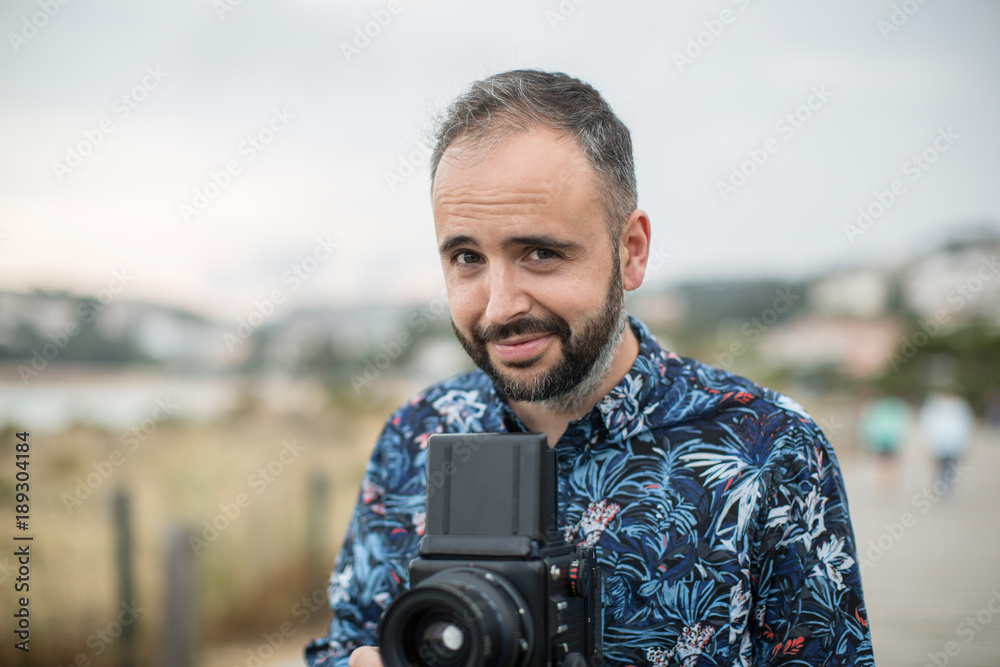 Cheerful man with camera