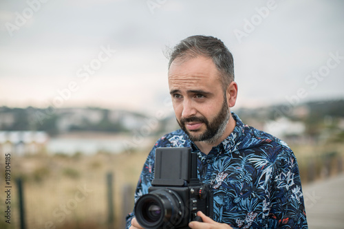 Adult photographer with camera with copy space