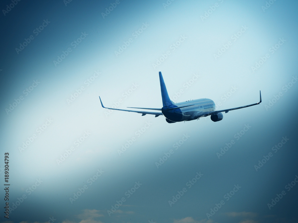 Naklejka premium Flight of passenger aircraft with retracted landing gear