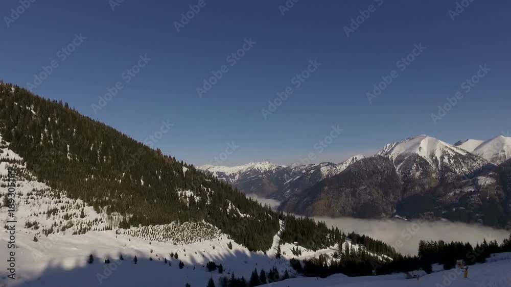 Bad Gastein, Austria, January 2018: Bad Gastein ski resort with snow-covered slopes in winter. Skiers and snowboarders ride on the prepared routes in the mountains. European Alps