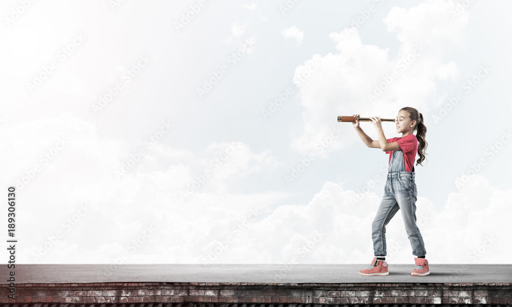 Concept of careless happy childhood with girl exploring this wor Concept of careless happy childhood with girl exploring this wor