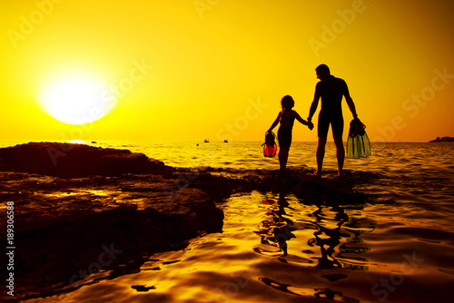 Father and daughter hand in hand on the rock, Croatian cost, seaboard.