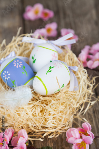 Easter eggs in nest and flowers