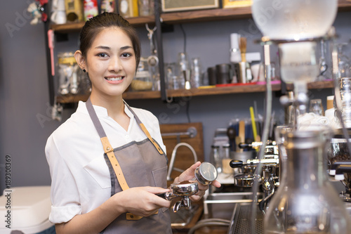 Asian barista woman make a coffee at bar. Woman success to make coffee.