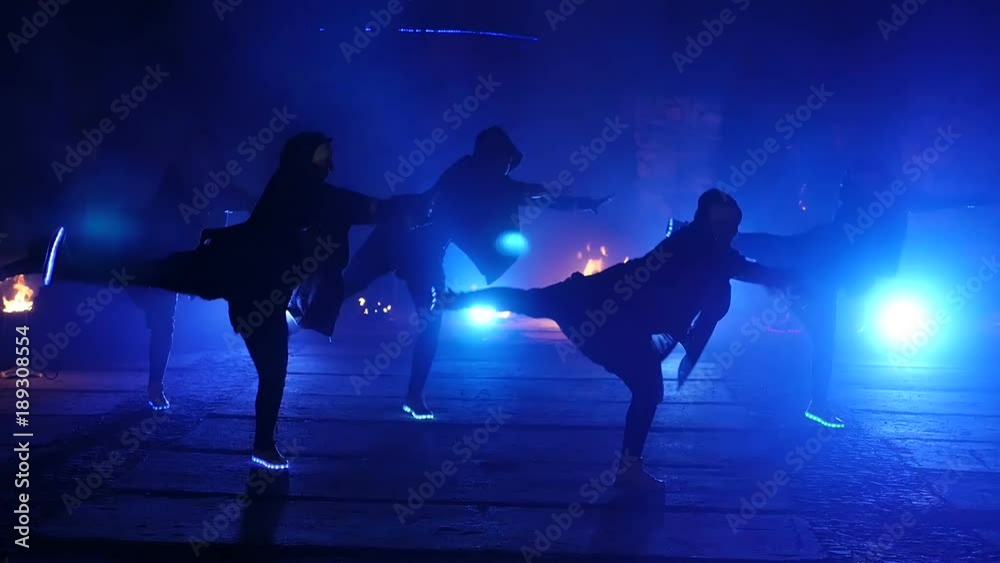 Street dancing. Slow motion. Five dancers dance in the night with shoes
