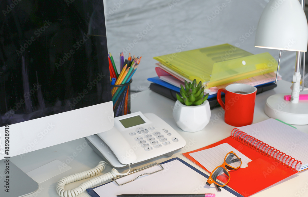 Office table with blank notepad and laptop Office table with blank notepad and laptop