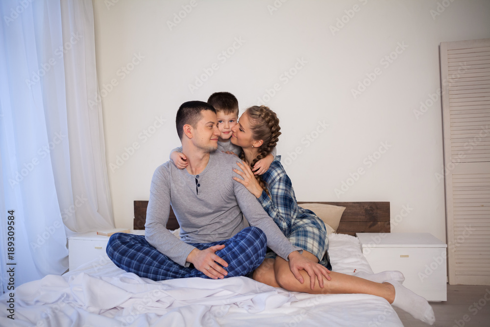 mom dad and son lie on the bed at home dream mom dad and son lie on the bed at home dream