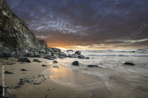 Natural rocks in the sea with beautiful sunset sky on the beach of Silistar, Bulgaria