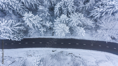 Aerial view of road through a winter forest. photo