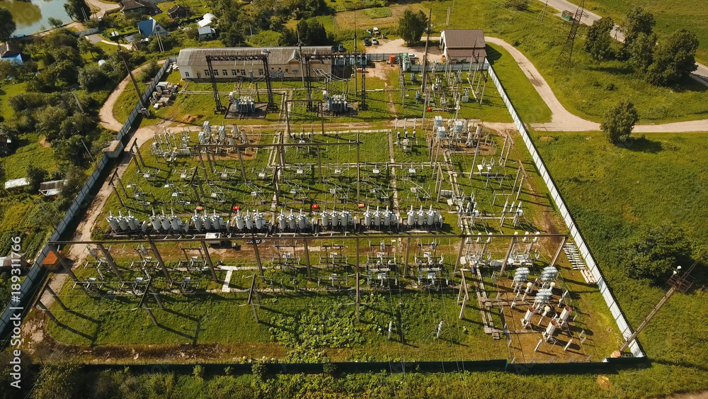 Aerial view Power plant, transformation station, cables and wires. High voltage electric power substation. Electrical power transformer in high voltage substation,