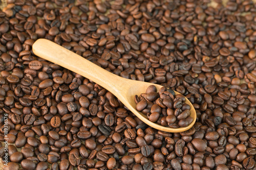 Coffee beans whit wooden spoon on wood 