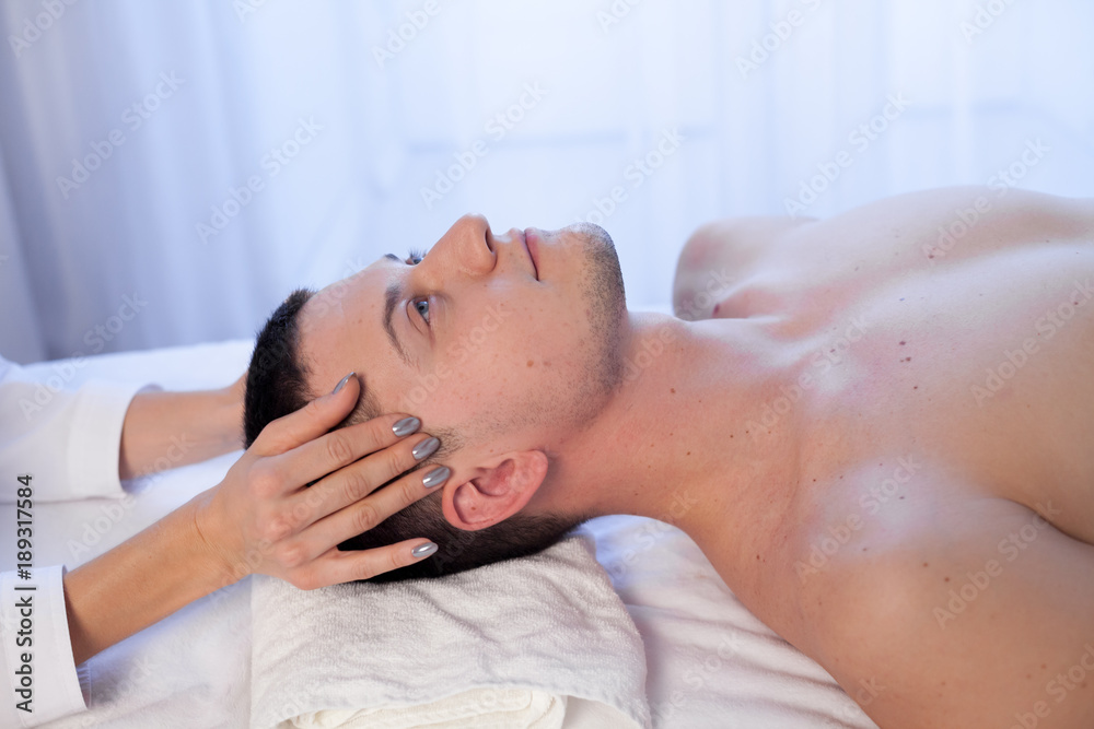male masseur doing massage health spa procedure male masseur doing massage health spa procedure