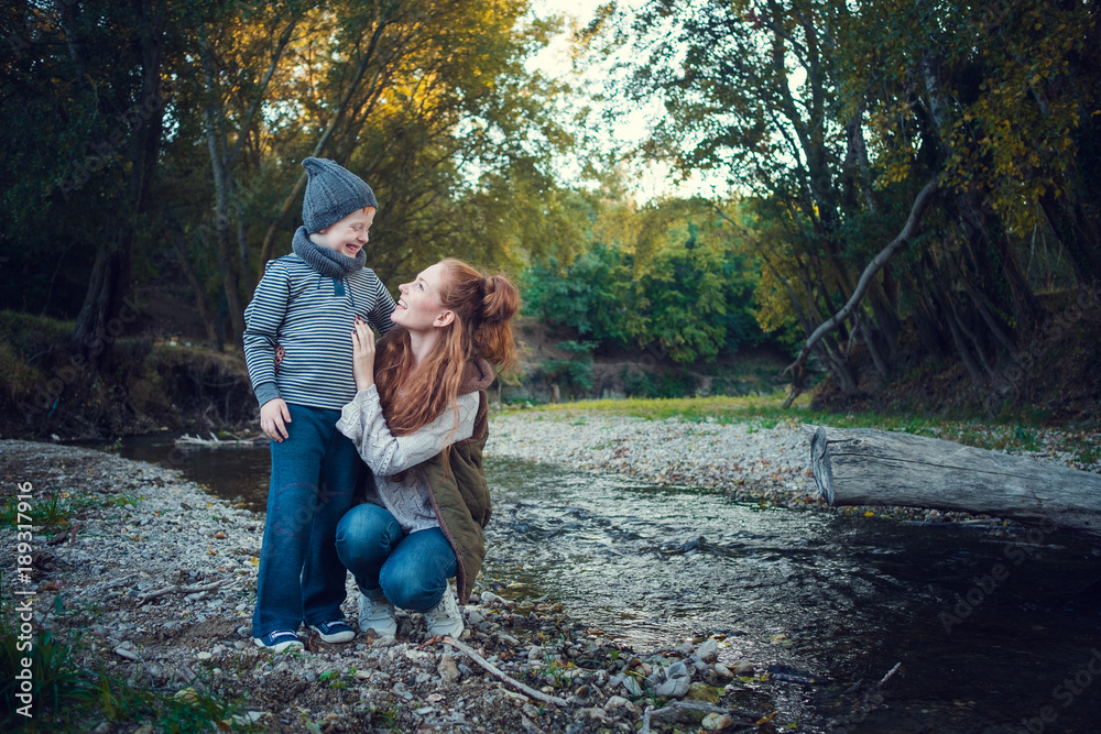 Fototapeta premium A series about happy red-haired. The elder sister and younger brother and sister. Park, autumn, river