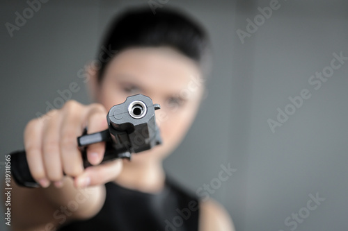 woman hand with a gun © PRASERT
