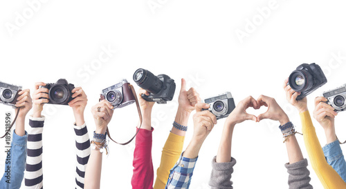 Different color hands holding  Cameras photo