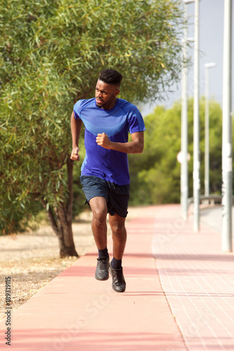 healthy young african man running outside