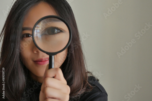 woman searching, viewing, finding with magnifying glass, girl searching concept