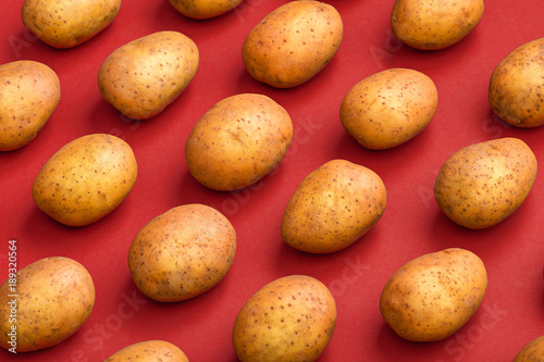 Potato on a colored background. Pattern of potato. Natural potato