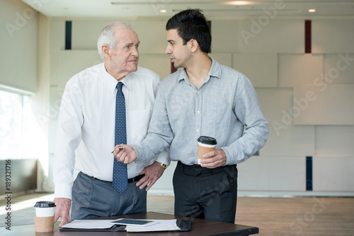 Young Manager Offering his Idea to Skeptical Boss  photo