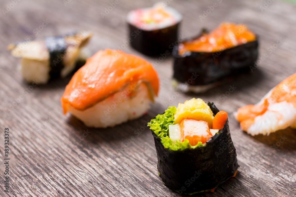 Sushi Set sashimi and sushi rolls served on wood slate Sushi Set sashimi and sushi rolls served on wood slate