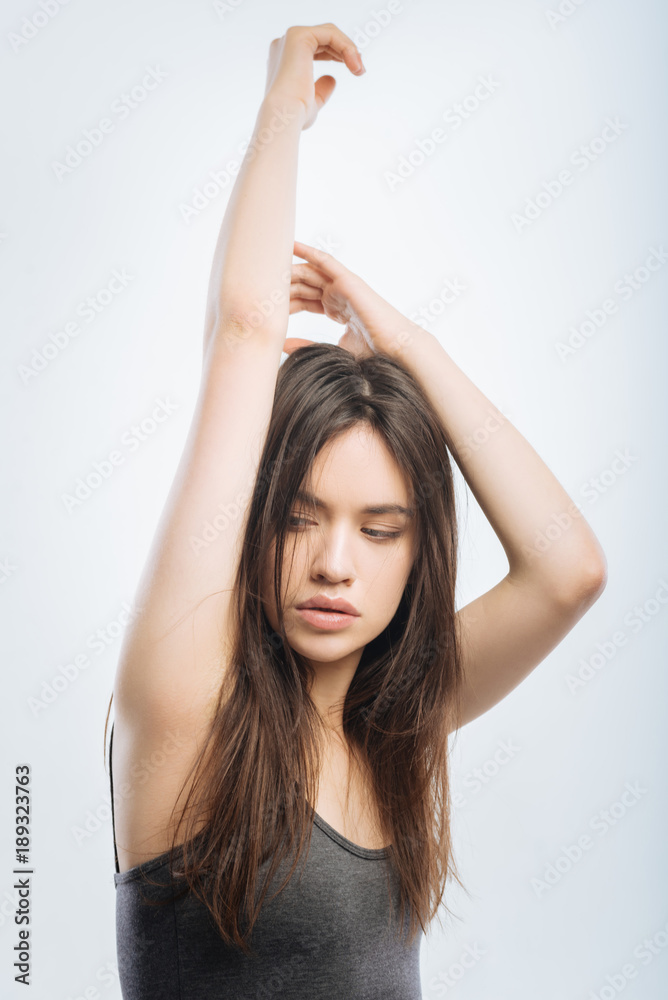 Good morning. Beautiful adorable brunette woman rising her hands while  gazing aside and getting ready for a new day Stock-Foto | Adobe Stock