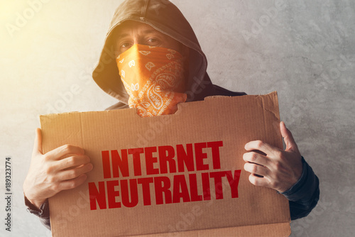 Slika na platnu Hooded activist protestor holding Internet neutrality protest sign