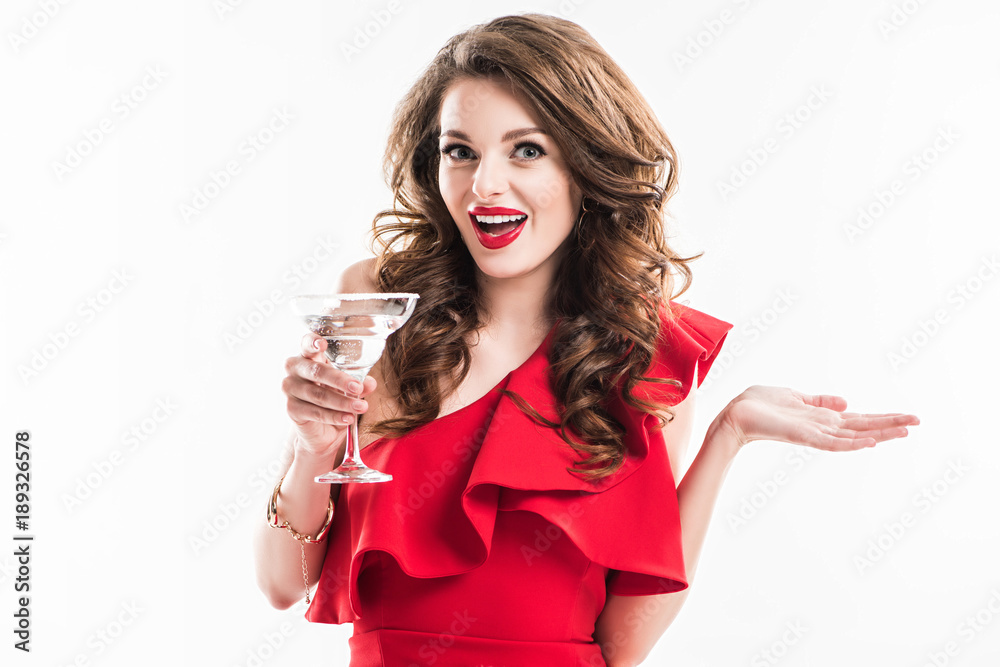 surprised fashionable girl in red dress holding glass of cocktail isolated on white surprised fashionable girl in red dress holding glass of cocktail isolated on white